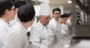 Group of chefs in a kitchen cooking